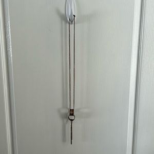 Copper colored double ring necklace with tassel